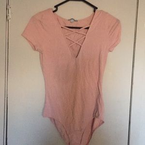 A pink onesie with a v-neck